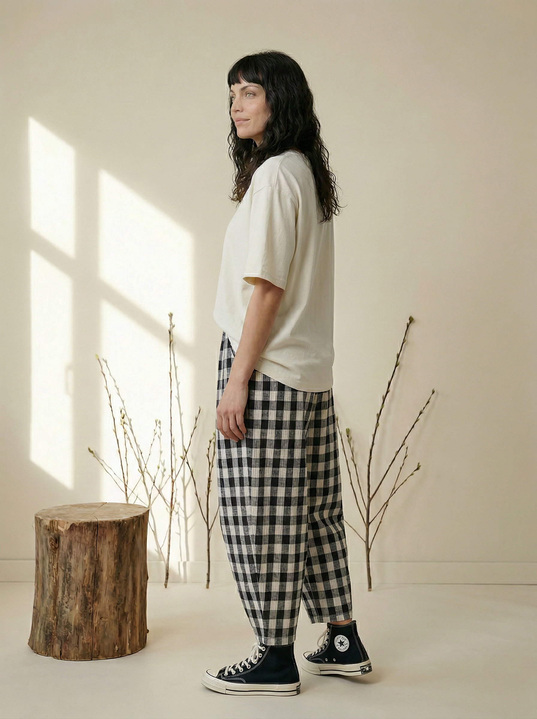 Girl wears cap and clutch bag in the kate stripe trouser 