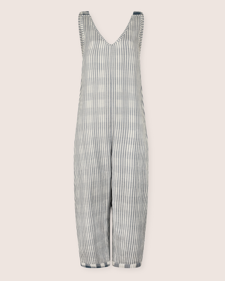 The Grace Reversible Blue Check Dungarees feature a sleeveless design with a V-neckline and cropped legs. Crafted from organic cotton, they add elegance to any sustainable wardrobe with their blue check pattern on a light neutral background.