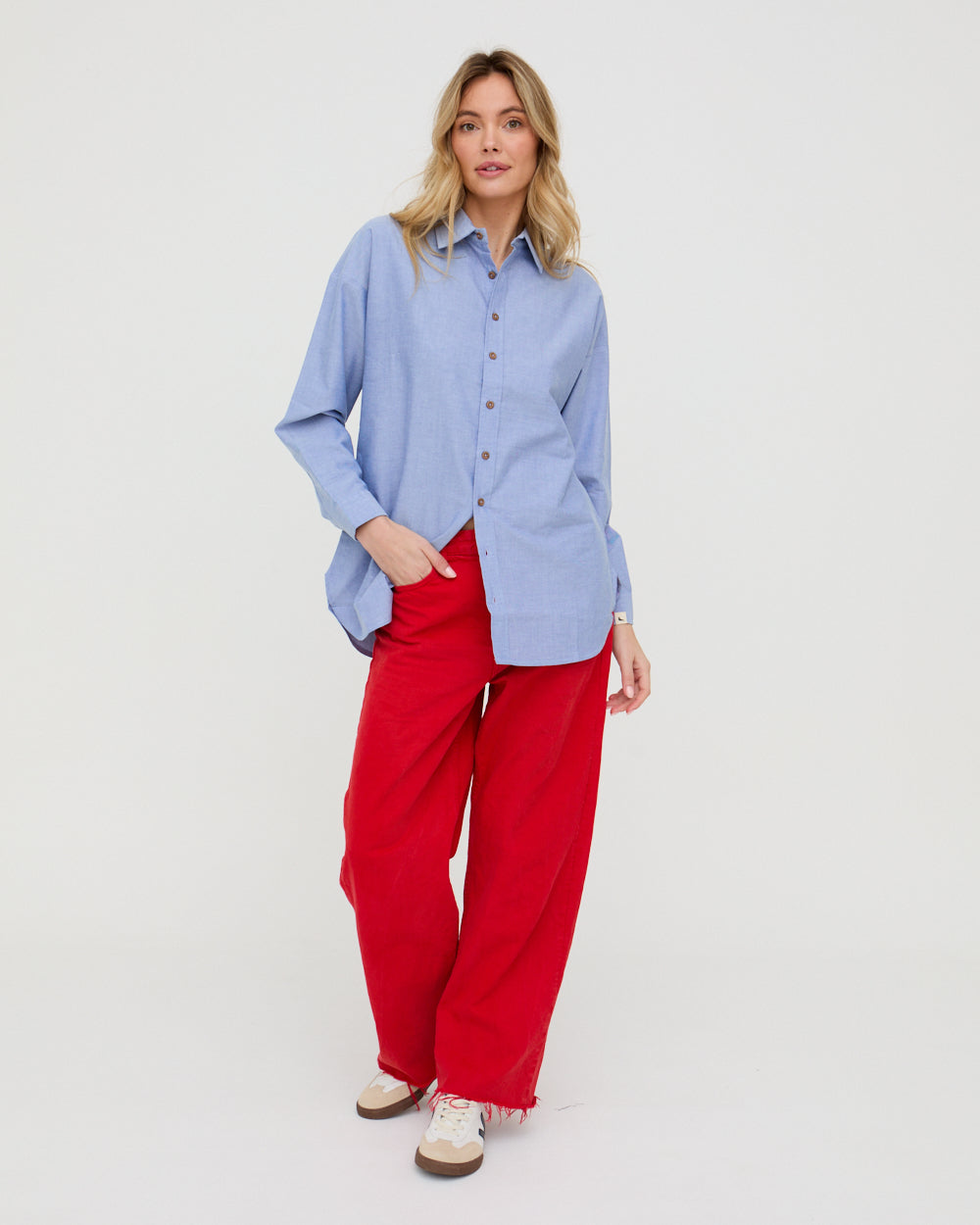 girl wearing bea blue shirt with red trousers 