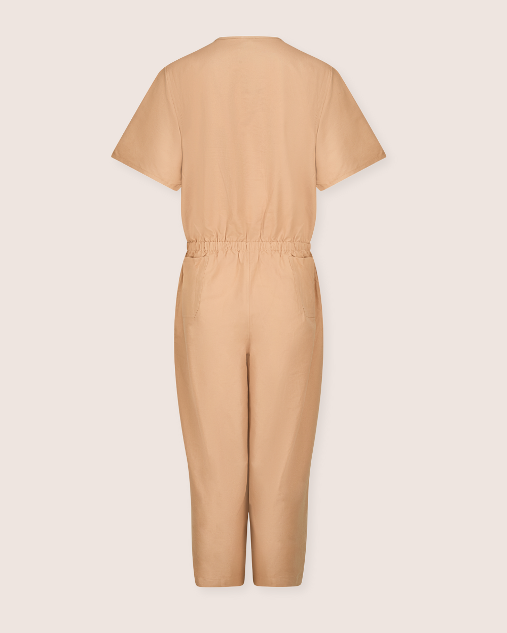 The Ethel Plain Clay Jumpsuit is beige and short-sleeved, made from organic cotton with a cinched waist. Displayed from the back to showcase its solid simplicity against a light background, it features an easy access breastfeeding option for convenience.