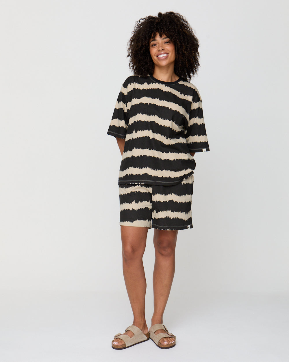 Woman wearing a black and white striped dress on a white background