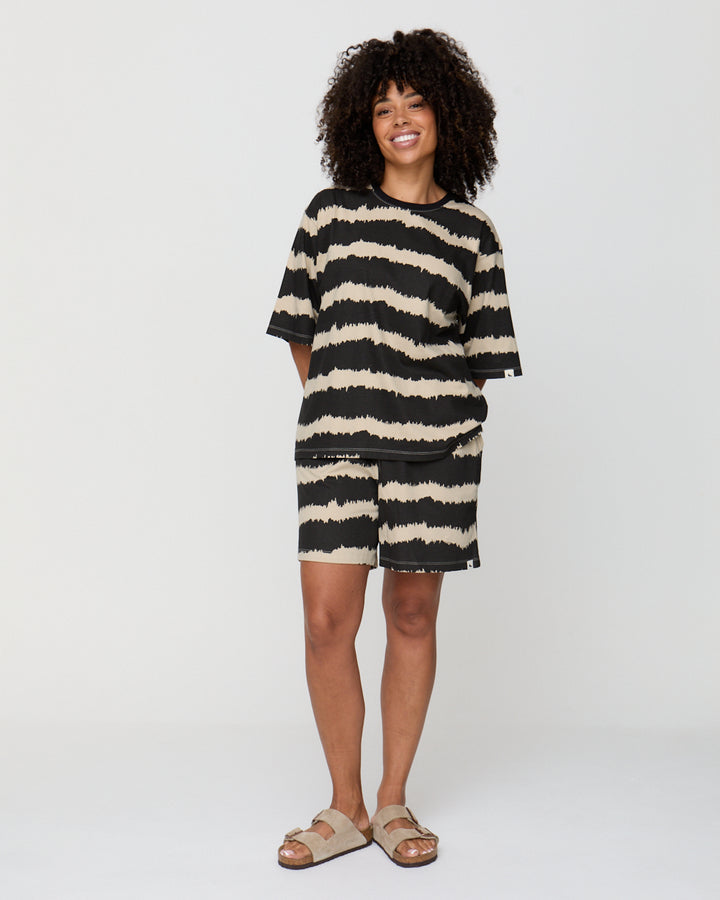 Woman wearing a black and white striped dress on a white background