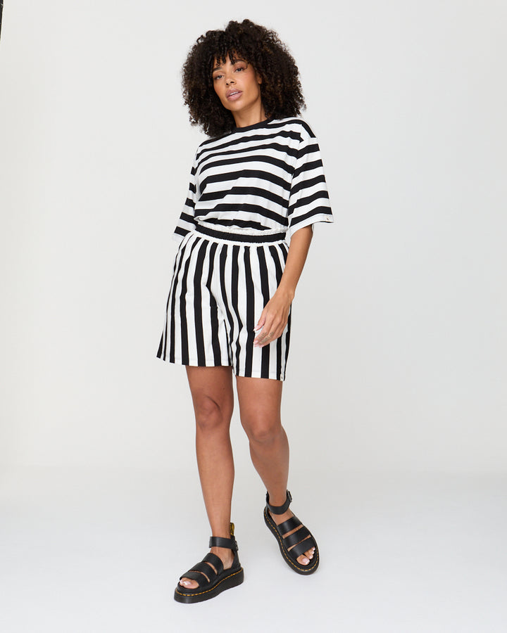 Woman wearing a black and white striped outfit on a white background