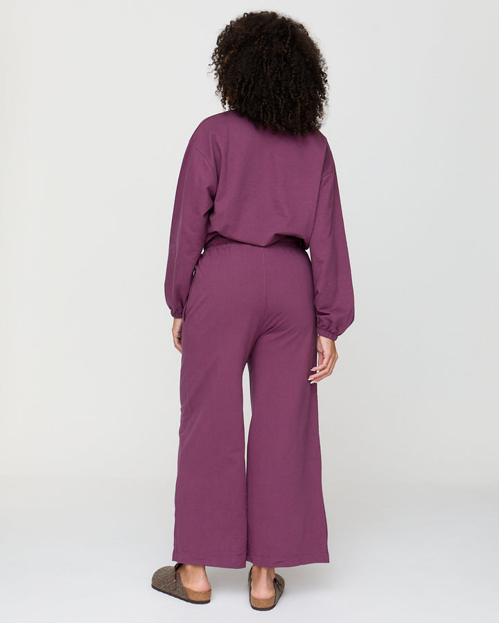 Person wearing a purple outfit on a white background