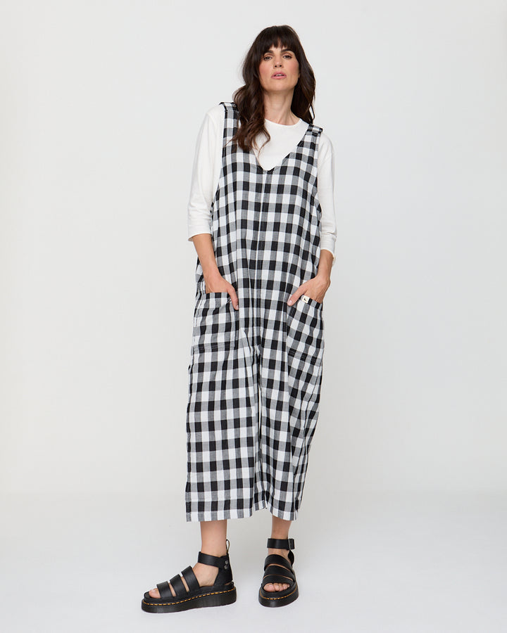 Woman wearing a black and white checkered dress against a white background