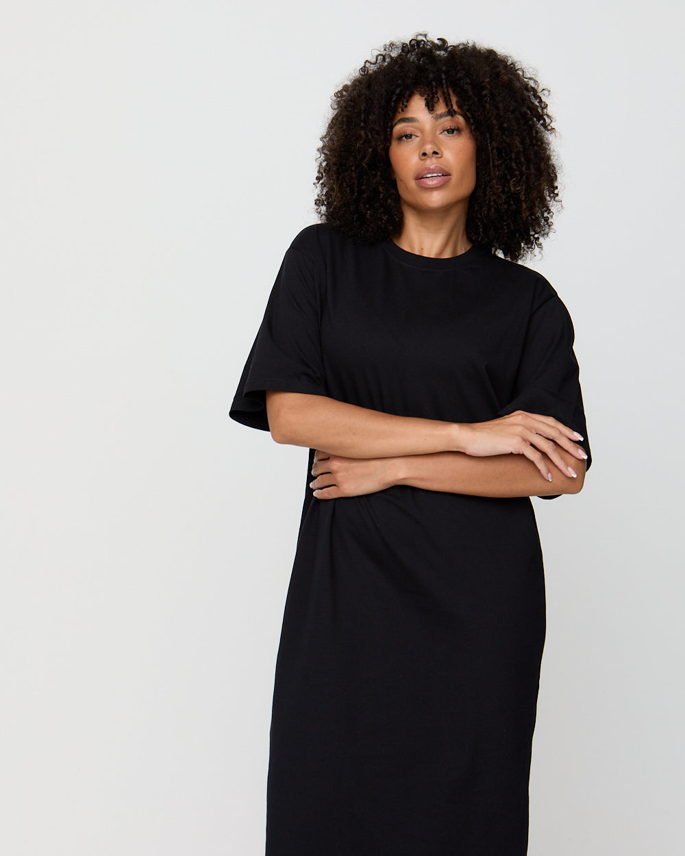 Woman wearing a black dress against a white background