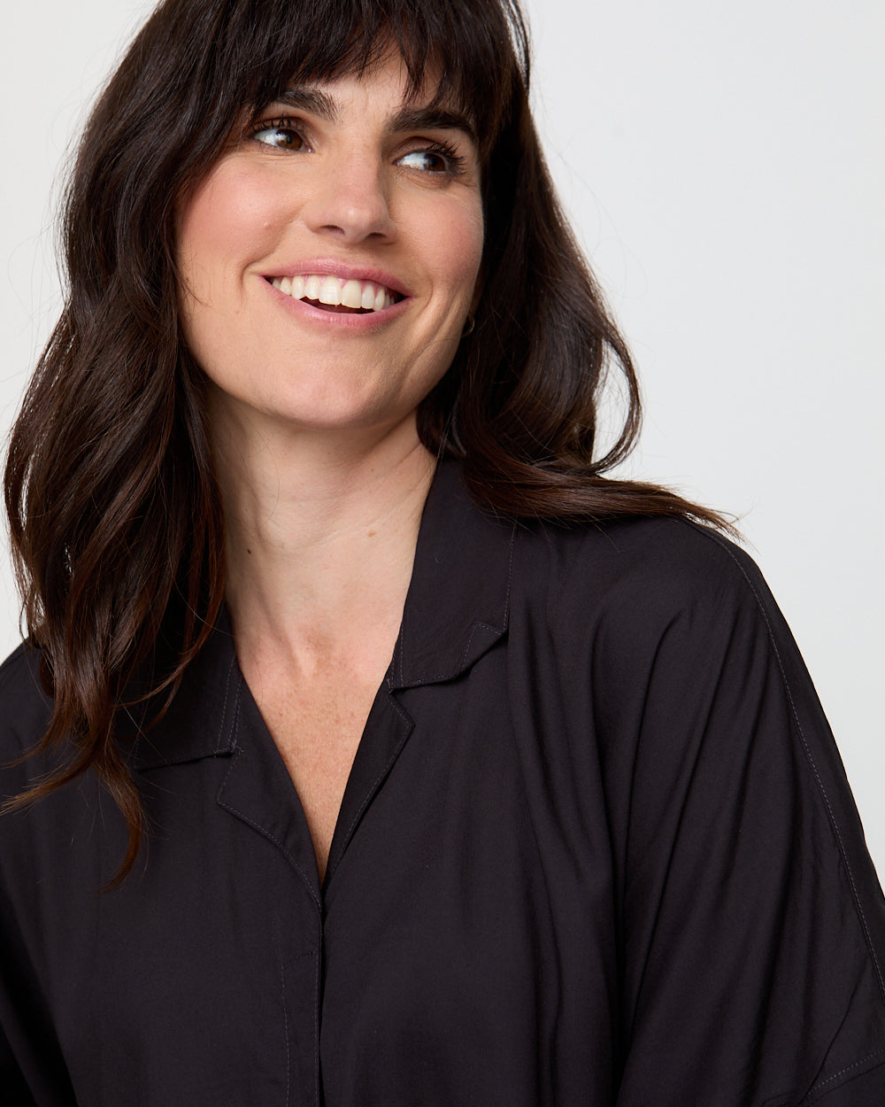 Woman wearing a black shirt against a plain background
