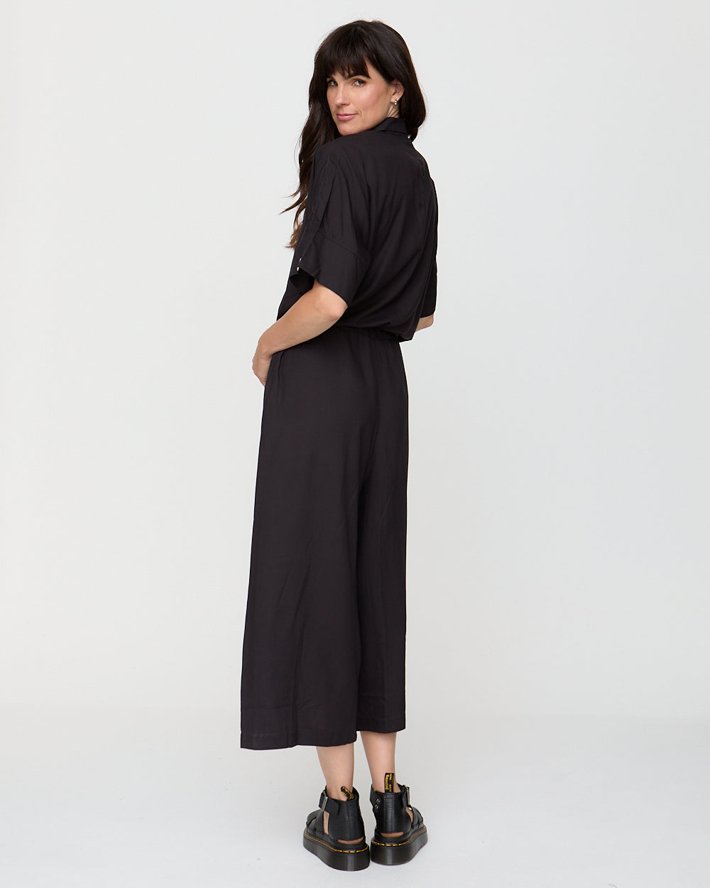 Woman wearing a black dress on a white background