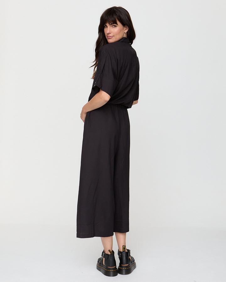Woman wearing a black dress on a white background