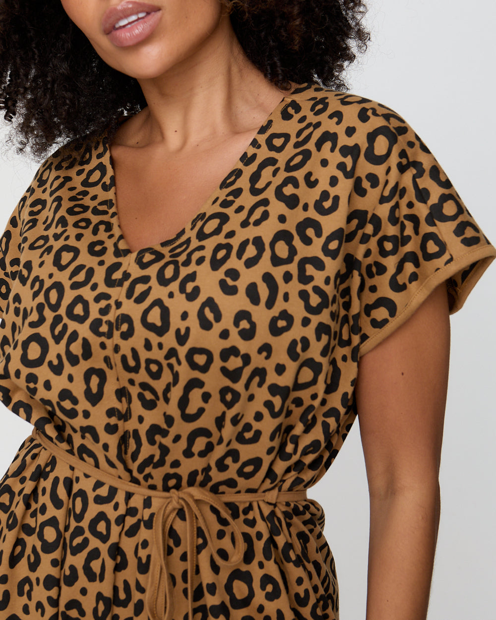 Leopard print dress worn by a model on a plain background