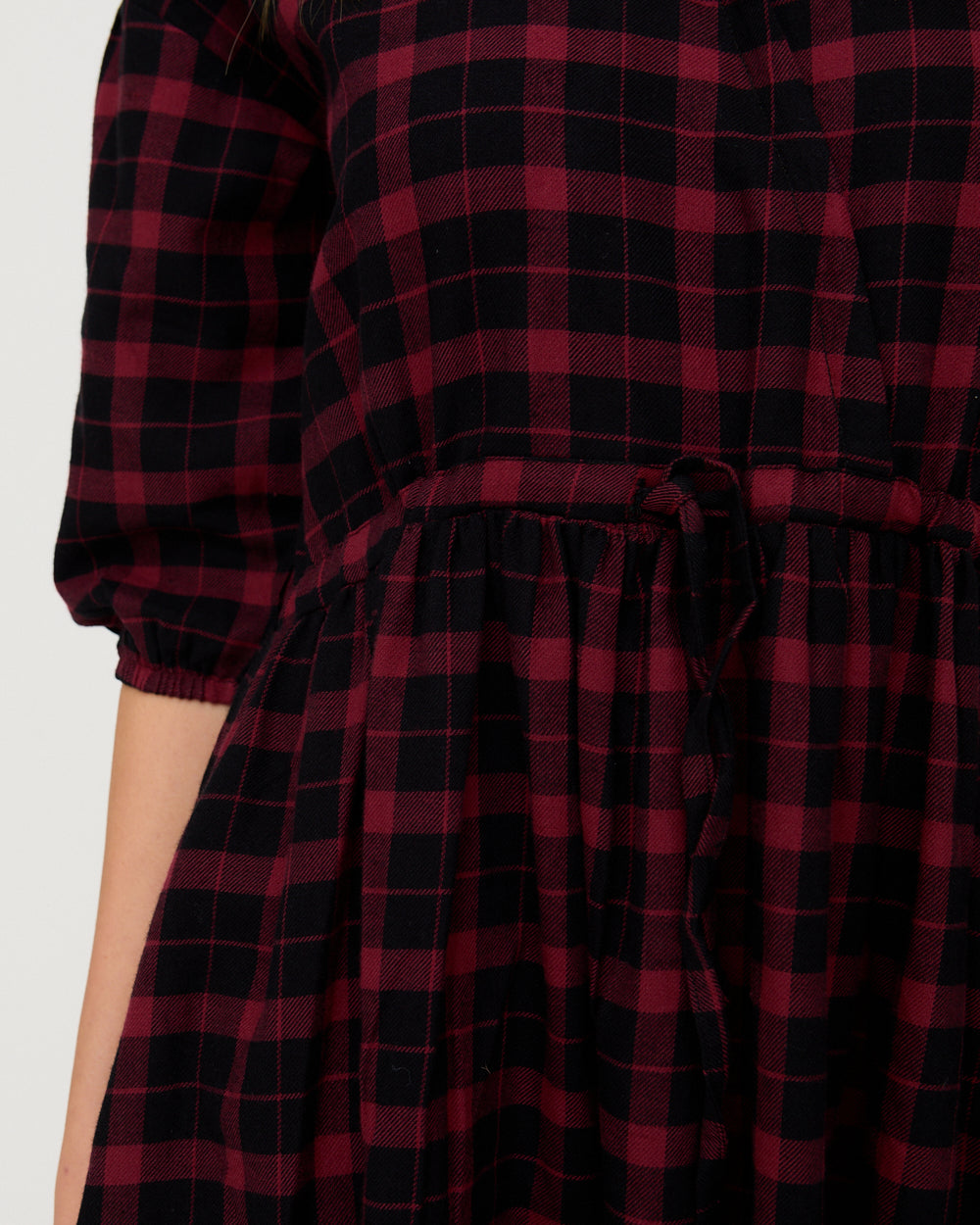 Red and black checkered dress with a white background