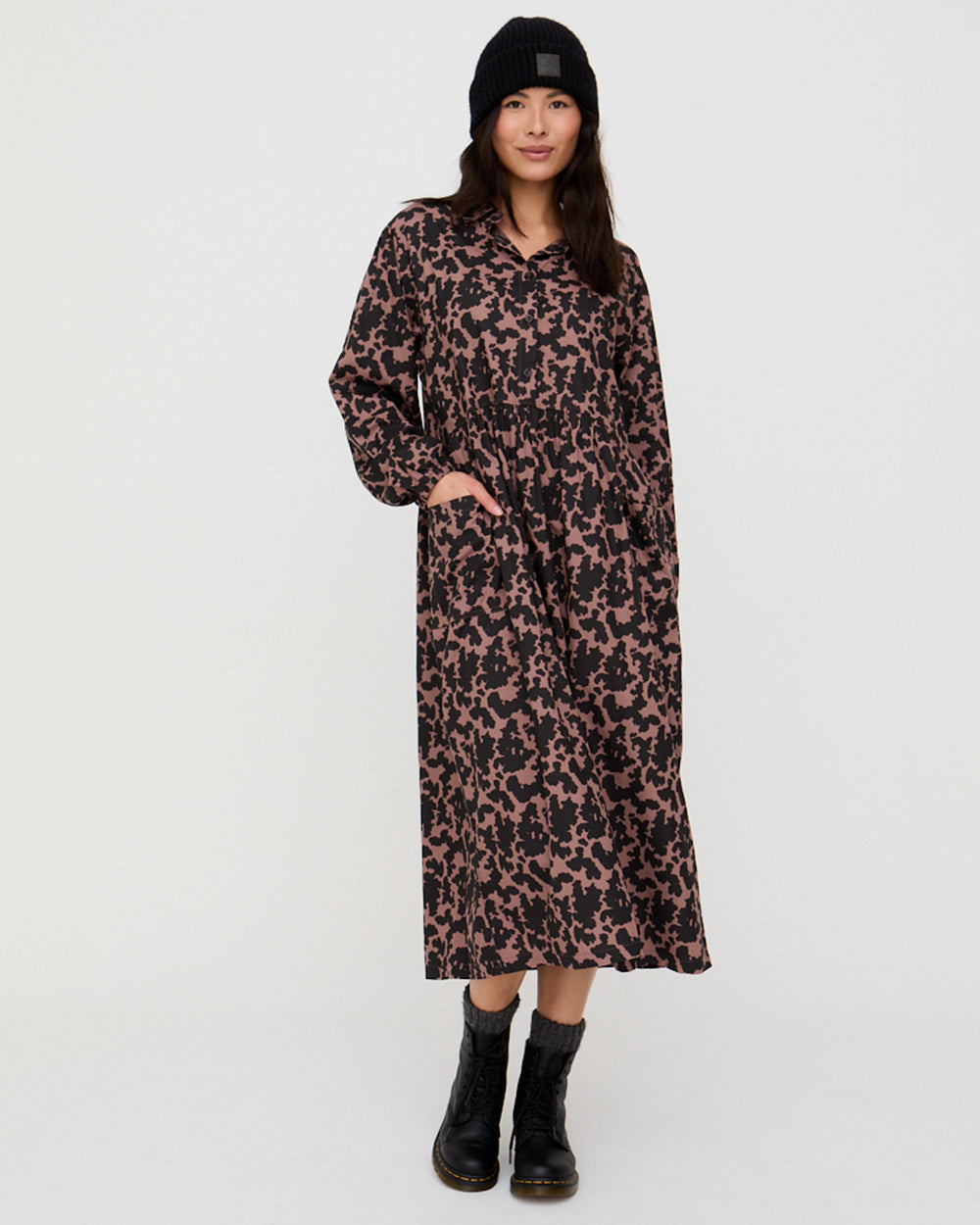 Woman wearing a leopard print dress on a white background