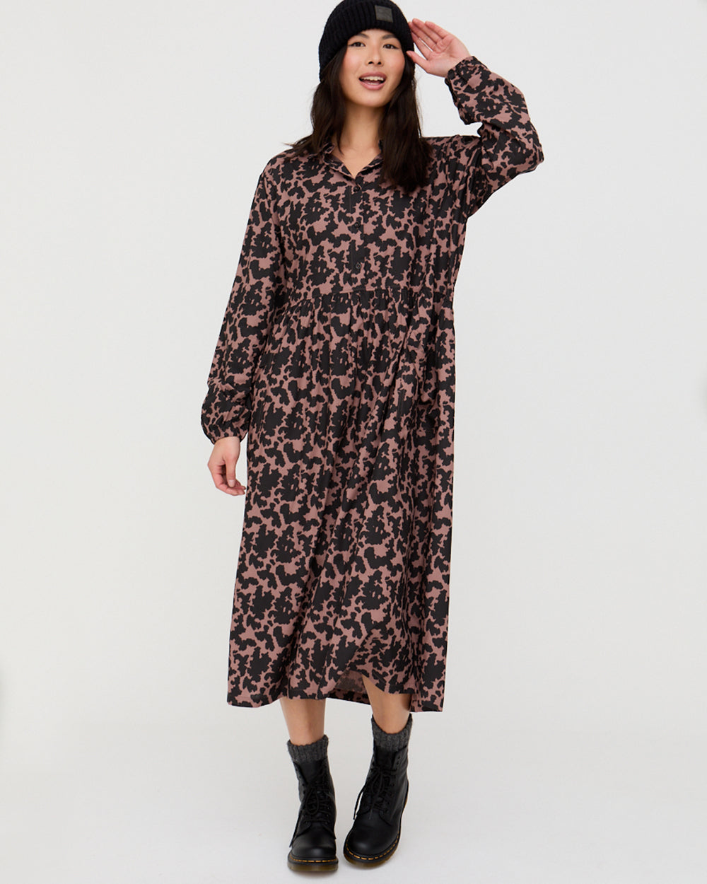Woman wearing a leopard print dress on a white background