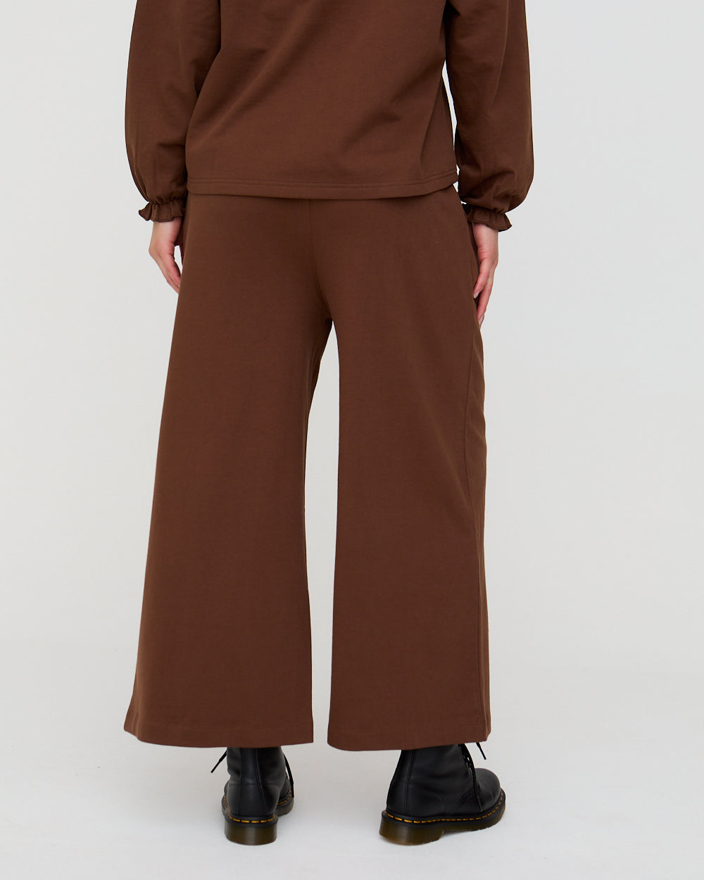Brown outfit with wide-leg pants and a matching top on a white background
