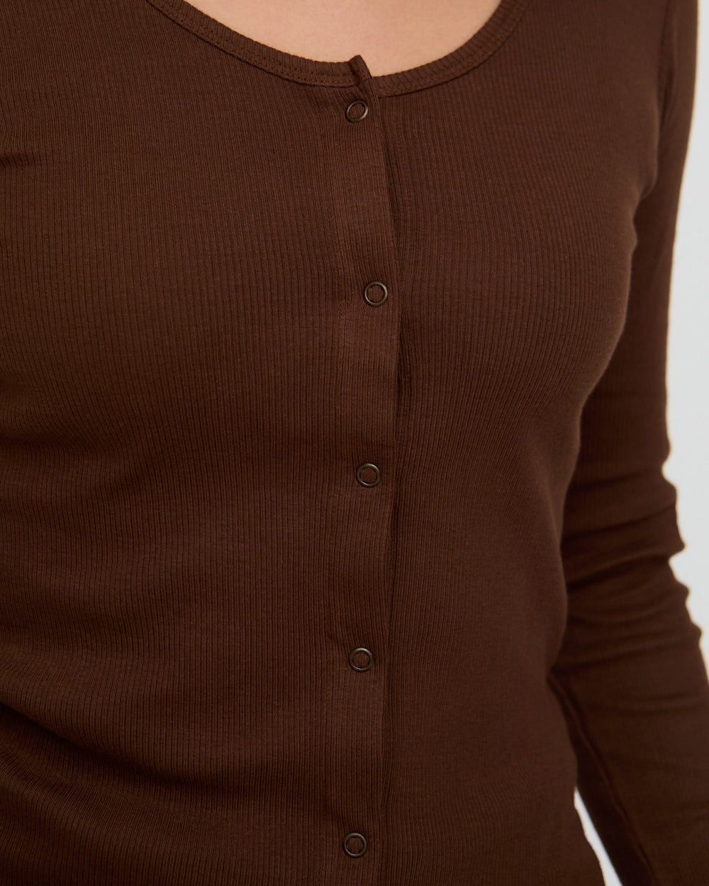Brown long-sleeve shirt with buttons on a white background