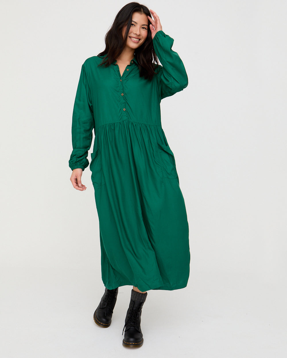 Woman wearing a green dress on a white background