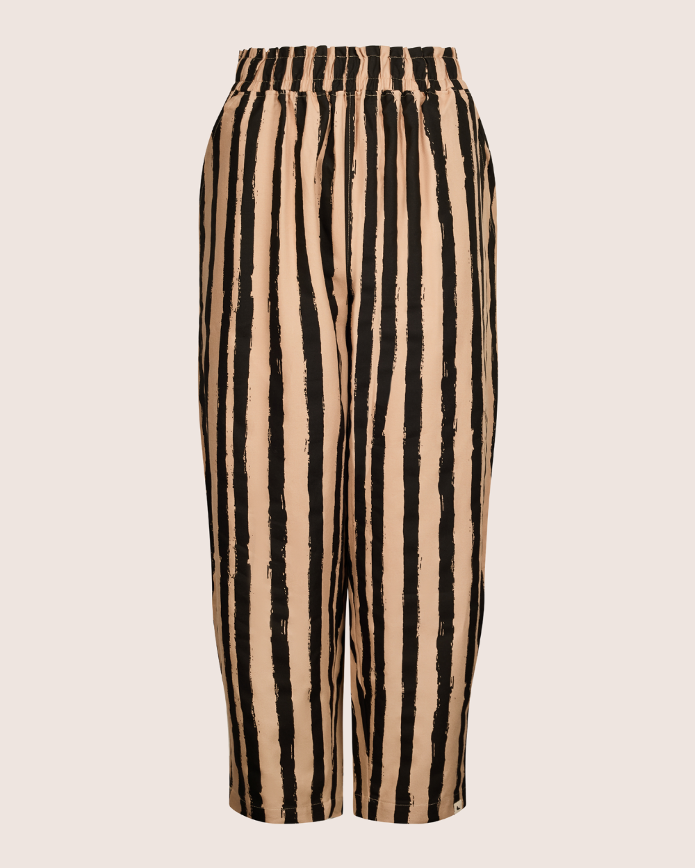 The Kate Painted Stripe Trousers are beige with vertical black stripes, featuring an elastic waistband and barrel leg fit. Made from organic cotton, they offer a lightweight and simple design with a relaxed silhouette—perfect for sustainable wardrobes.