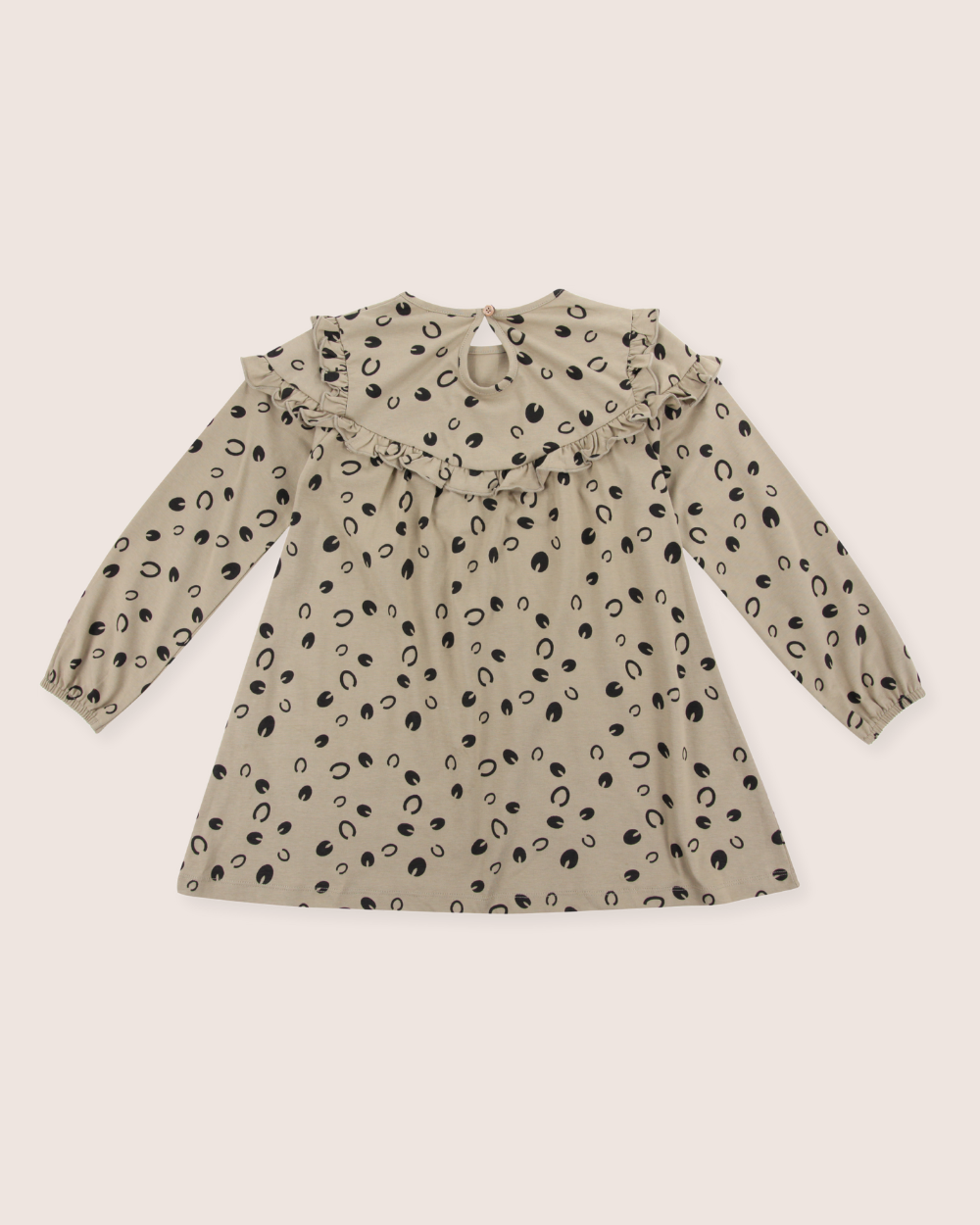 The Clip Clop Dress is a long-sleeved, beige childrens dress made from 100% GOTS organic cotton. It features a ruffled collar, an Easy Fit design with black oval dots, a round neckline, and a button closure at the back.