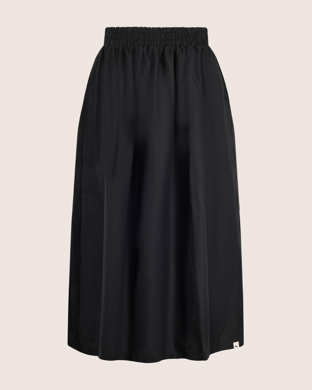 The Joyce Easy Fit Black Skirt is a versatile long A-line design with an elastic waistband, displayed on a plain background. Its lightweight fabric ensures comfort, making it perfect for any sustainable wardrobe, suitable for both casual and formal occasions.