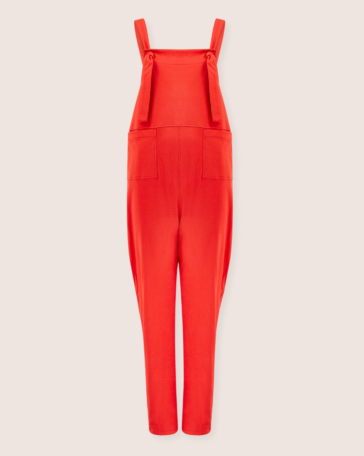 Elevate your style with the Lila Plain Red Dungarees, crafted from soft organic cotton. Featuring tied straps and two front pockets, theyre an ideal choice for conscious consumers seeking a chic alternative to traditional jumpsuits, displayed beautifully on a light background.