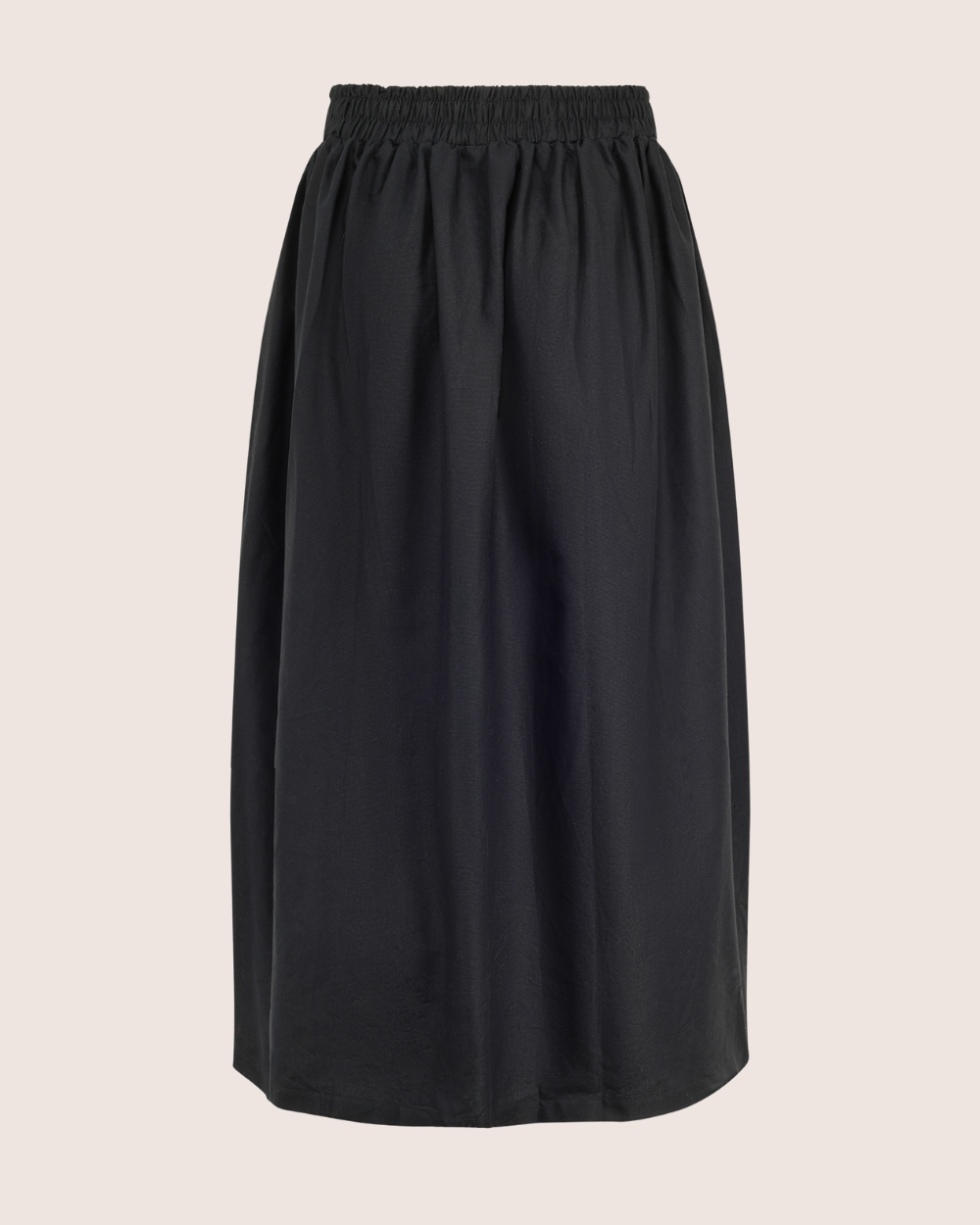 The Joyce Easy Fit Black Skirt, knee-length with an elasticated waistband, is displayed on a light beige background. Its relaxed fit and slightly gathered design make it ideal for a sustainable wardrobe, offering both casual comfort and style.