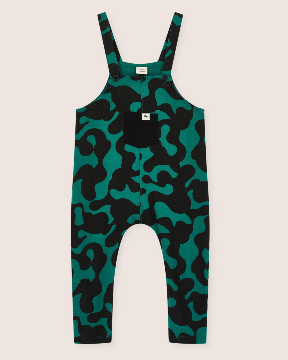 The Misty Print Dungarees are gender-neutral green and black overalls with an abstract wavy pattern on organic cotton jersey. They feature adjustable straps, a small black chest pocket, and a simple white background that highlights the vibrant design—ideal for any sustainable wardrobe.