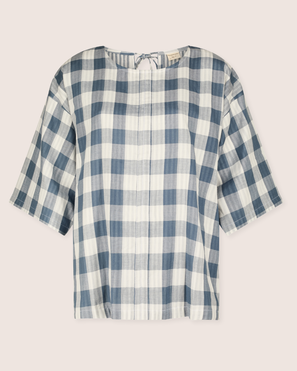 The Doris Tie Back Blue Check Top features blue and white large checkered patterns, a short-sleeve design with a round neckline, crafted from organic cotton for a light and airy feel, ideal for casual wear. Displayed against a plain background.