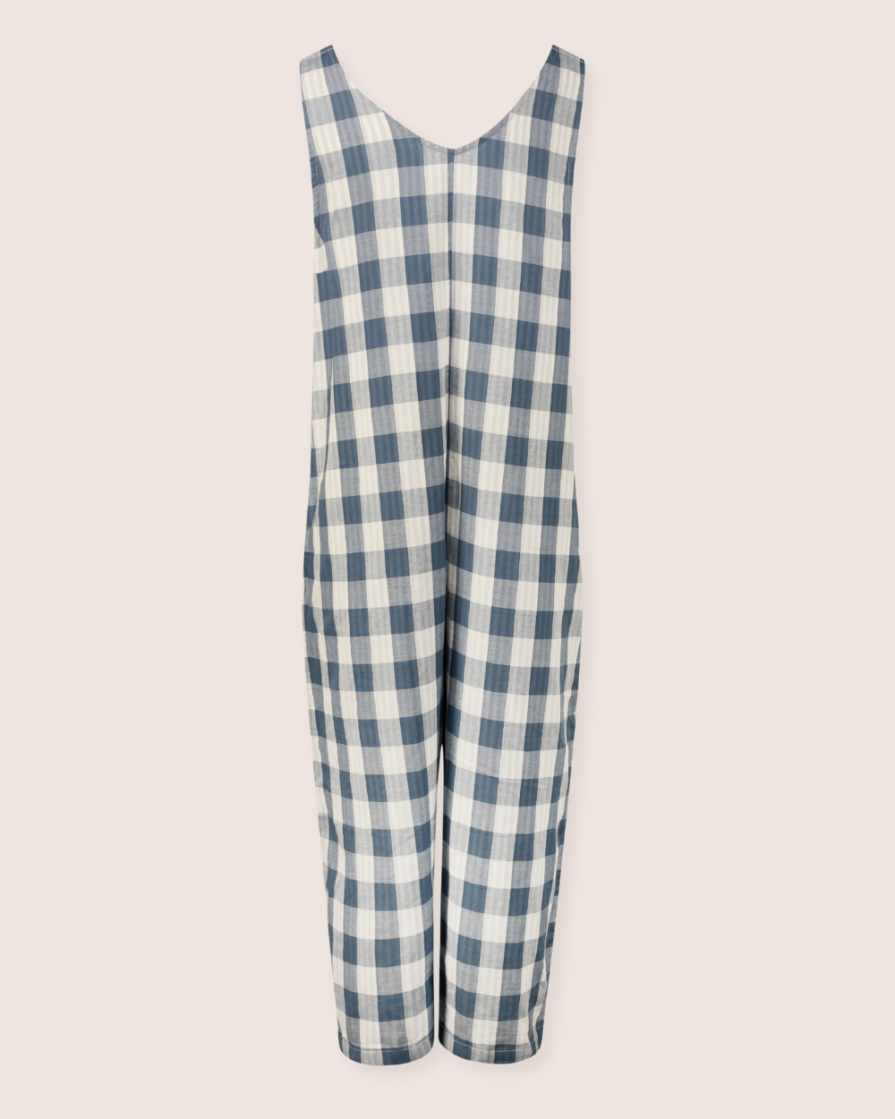 The Grace Reversible Blue Check Dungarees, made from organic cotton, feature a blue and white checkered design. With a loose, comfy fit and V-neckline against a light backdrop, theyre an essential piece for any sustainable wardrobe.