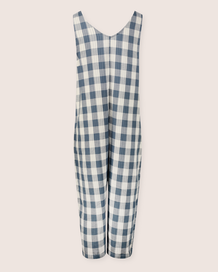 The Grace Reversible Blue Check Dungarees, made from organic cotton, feature a blue and white checkered design. With a loose, comfy fit and V-neckline against a light backdrop, theyre an essential piece for any sustainable wardrobe.