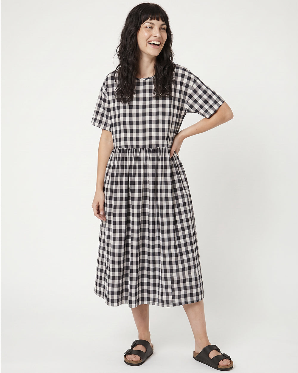 Woman wearing a black and white checkered dress on a white background