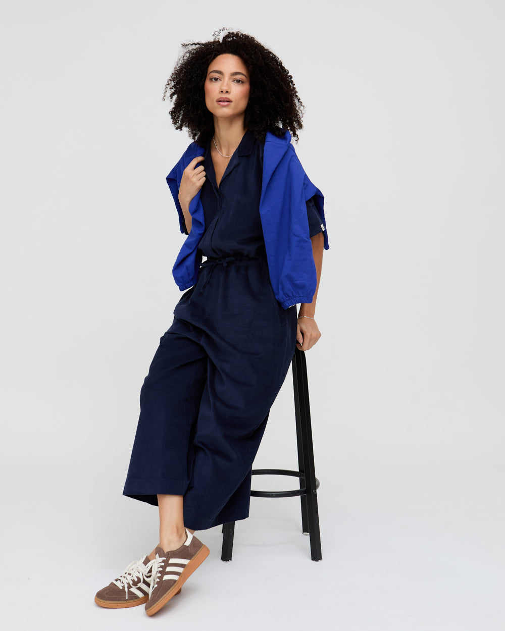 Woman wearing a blue outfit with a white background