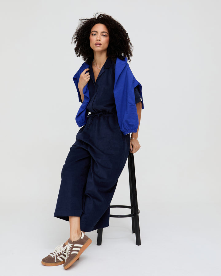 Woman wearing a blue outfit with a white background
