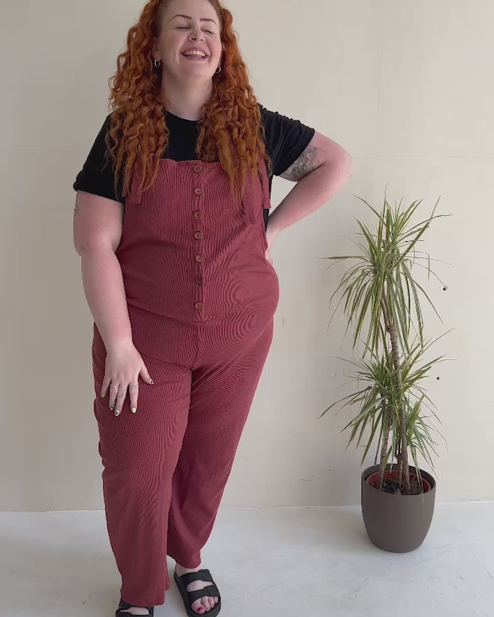 video shoiwng Erin Red Dungarees
