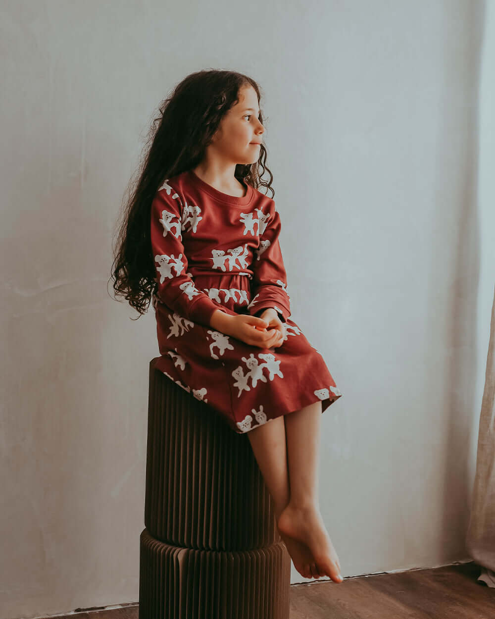 Girl wearing unisex organic cotton kids long-sleeve sweatshirt