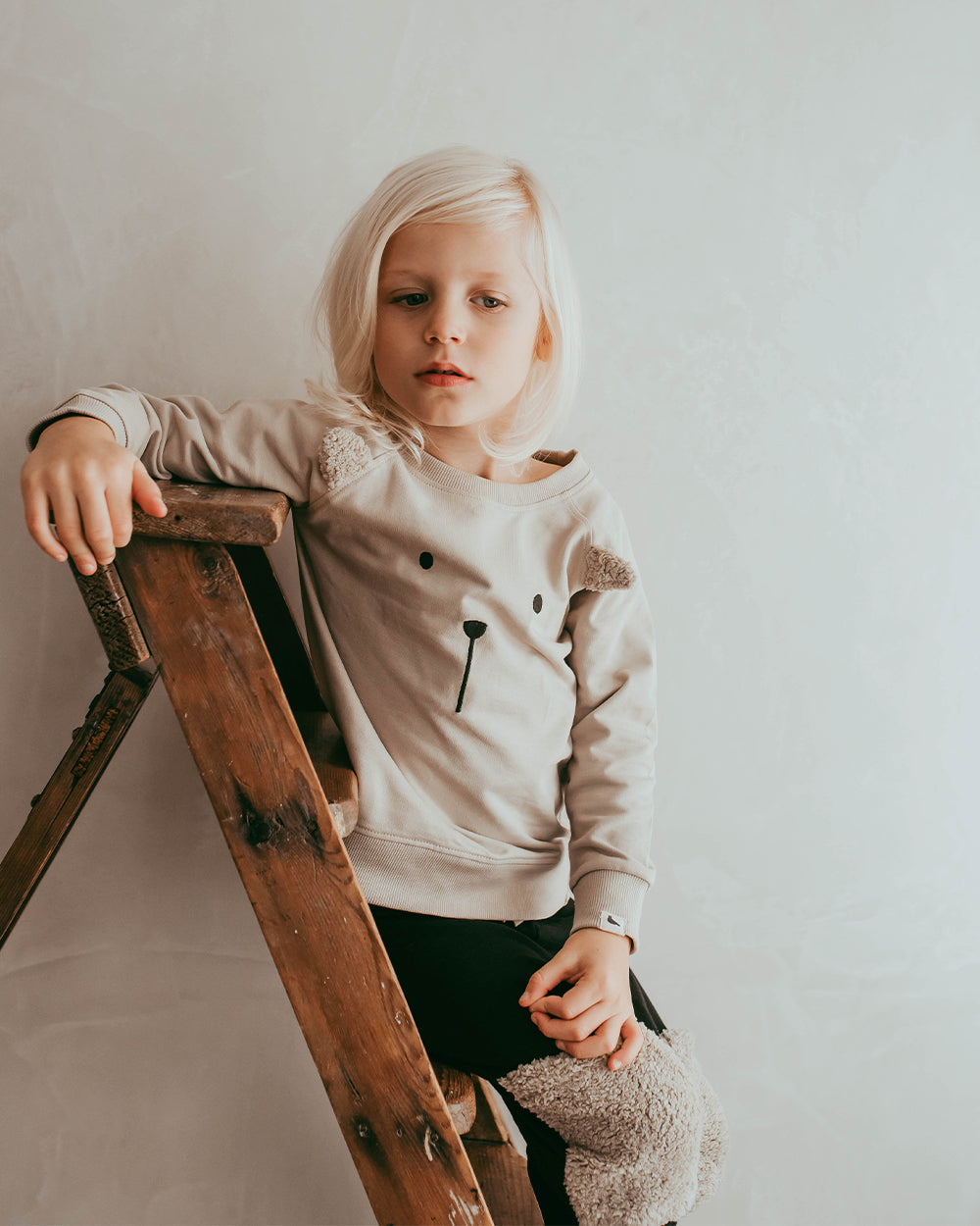 Boy wearing unisex organic cotton kids long-sleeve sweatshirt