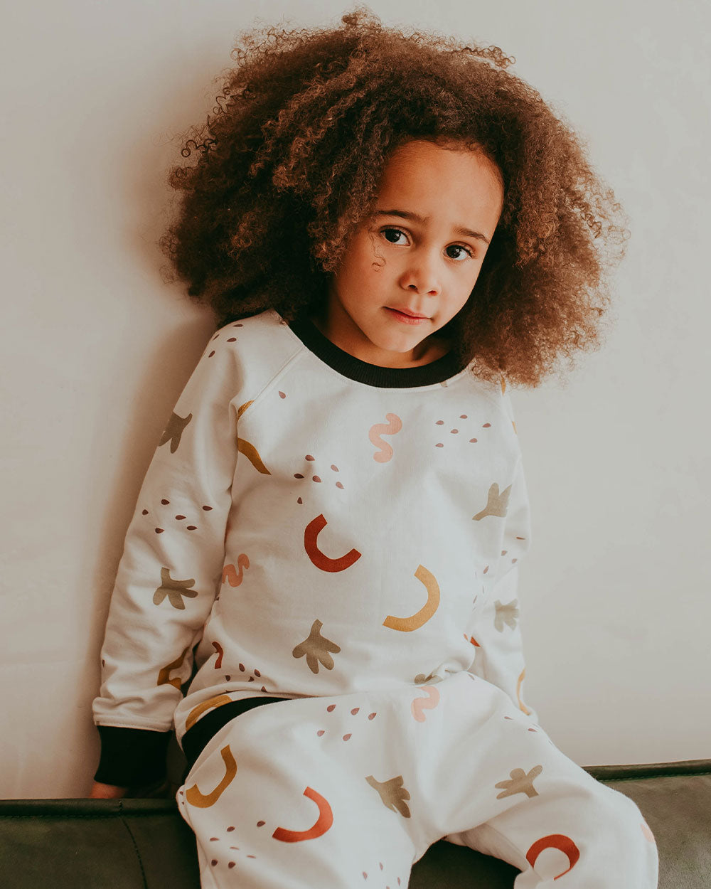 Girl wearing gender-neutral organic cotton kids sweatshirt