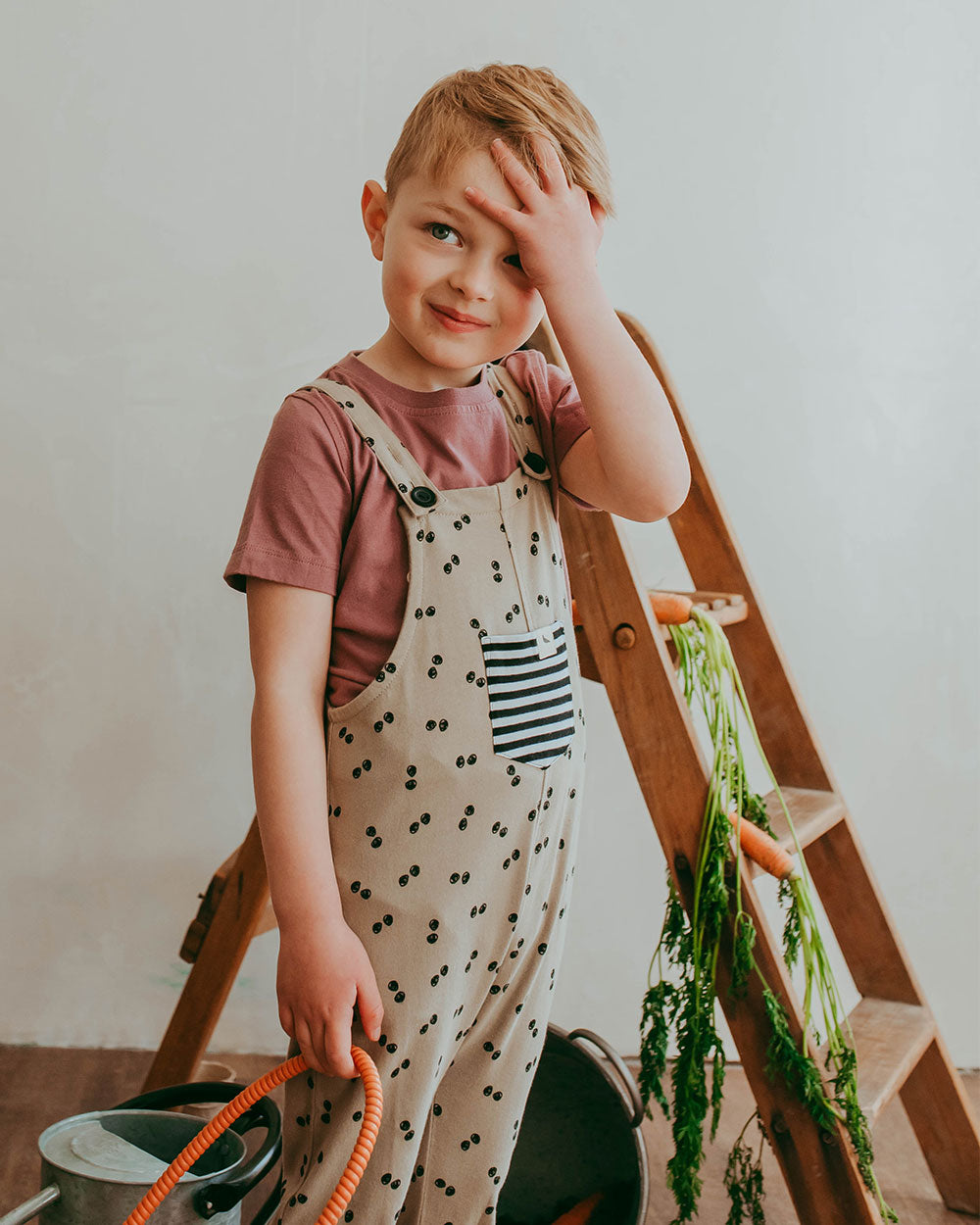 Boy wearing gender-neutral organic cotton kids dungarees