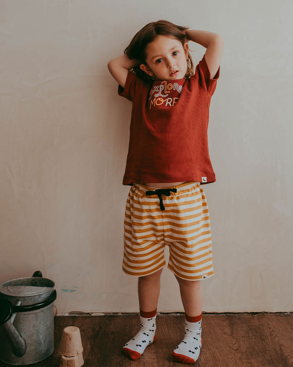Girl wearing gender-neutral organic cotton kids shorts